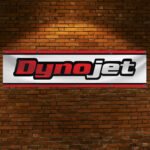 "Enhance your space with this 2x8 ft Dynojet flag banner, perfect for motorcycle enthusiasts and performance parts fans. Featuring bold Dynojet branding and sleek graphics, this banner is an ideal addition to garages, workshops, man caves, or motorcycle show displays. Crafted from durable, high-quality materials, it ensures vibrant colors and long-lasting appeal, suitable for both indoor and outdoor use. Show off your passion for motorcycle tuning and high-performance parts with this eye-catching banner that celebrates Dynojet’s reputation for precision and power. Whether you’re a racer, mechanic, or enthusiast, this Dynojet flag is the ultimate wall décor sign for those who demand performance and style."