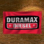 "Show your pride in Duramax Diesel power with this 3x5 ft banner, perfect for truck enthusiasts and fans of heavy-duty engines. Featuring bold Duramax Diesel branding and graphics, this durable banner is ideal for garages, man caves, workshops, or truck shows. Made from high-quality materials, it’s designed for both indoor and outdoor use, ensuring vibrant colors and long-lasting appeal. Celebrate the strength, performance, and legacy of Duramax Diesel engines with this must-have décor piece, perfect for showcasing your love for powerful, reliable diesel technology."