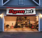 "Enhance your space with this 2x8 ft Dynojet flag banner, perfect for motorcycle enthusiasts and performance parts fans. Featuring bold Dynojet branding and sleek graphics, this banner is an ideal addition to garages, workshops, man caves, or motorcycle show displays. Crafted from durable, high-quality materials, it ensures vibrant colors and long-lasting appeal, suitable for both indoor and outdoor use. Show off your passion for motorcycle tuning and high-performance parts with this eye-catching banner that celebrates Dynojet’s reputation for precision and power. Whether you’re a racer, mechanic, or enthusiast, this Dynojet flag is the ultimate wall décor sign for those who demand performance and style."