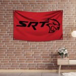 "Showcase your passion for high-performance vehicles with this Dodge SRT flag, perfect for car enthusiasts and racing fans. Featuring bold SRT branding and iconic Dodge graphics, this flag is ideal for garages, man caves, workshops, or car shows. Made from durable, high-quality materials, it’s designed for both indoor and outdoor use. Celebrate the power, speed, and legacy of Dodge SRT with this vibrant and stylish flag, a must-have décor piece for any true fan of American muscle and performance engineering."