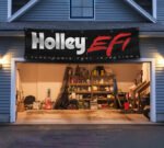 "Showcase your passion for high-performance racing with this 2x8 ft Holley EFI (Electronic Fuel Injection) Banner. Featuring bold Holley EFI branding, this flag is perfect for dirt racing enthusiasts, car racers, and fans of cutting-edge automotive technology. Crafted from durable materials, it ensures vibrant colors and long-lasting performance, making it suitable for both indoor and outdoor use. Ideal for your man cave, garage, or racing workshop, this banner celebrates the power and precision of Holley's fuel injection systems in the world of motorsports. Add a dynamic touch to your space with this stylish décor piece that highlights your love for racing and performance engineering."