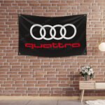 "Show your appreciation for Audi quattro with this 3x5 ft flag. Ideal for car racing shows, garages, man caves, and wall décor, this durable banner features the iconic Audi quattro branding. Perfect for indoor and outdoor use, it’s a must-have sign for motorsport enthusiasts looking to display their passion for legendary performance and all-wheel drive excellence."