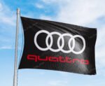 "Show your appreciation for Audi quattro with this 3x5 ft flag. Ideal for car racing shows, garages, man caves, and wall décor, this durable banner features the iconic Audi quattro branding. Perfect for indoor and outdoor use, it’s a must-have sign for motorsport enthusiasts looking to display their passion for legendary performance and all-wheel drive excellence."