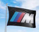 "Enhance your space with this 3x5 ft BMW M Power flag. Perfect for garages, shops, man caves, and wall décor, this durable banner features bold BMW Motorsport branding. Ideal for indoor and outdoor use, it’s a great sign for showcasing your passion for high-performance driving and BMW M Power’s legacy in motorsport."